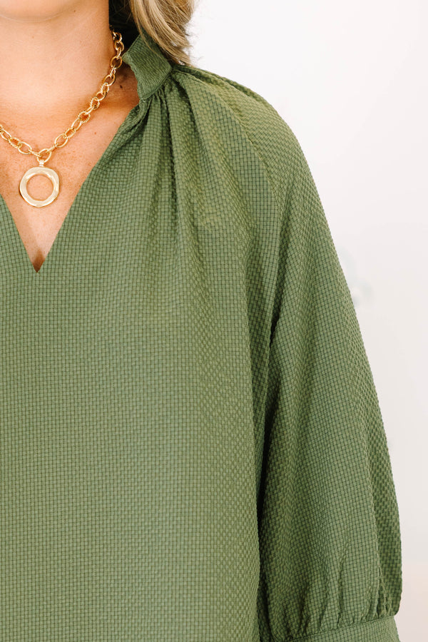 Plus Size olive textured v-neck top with three-quarter puff sleeves and a scalloped hem.