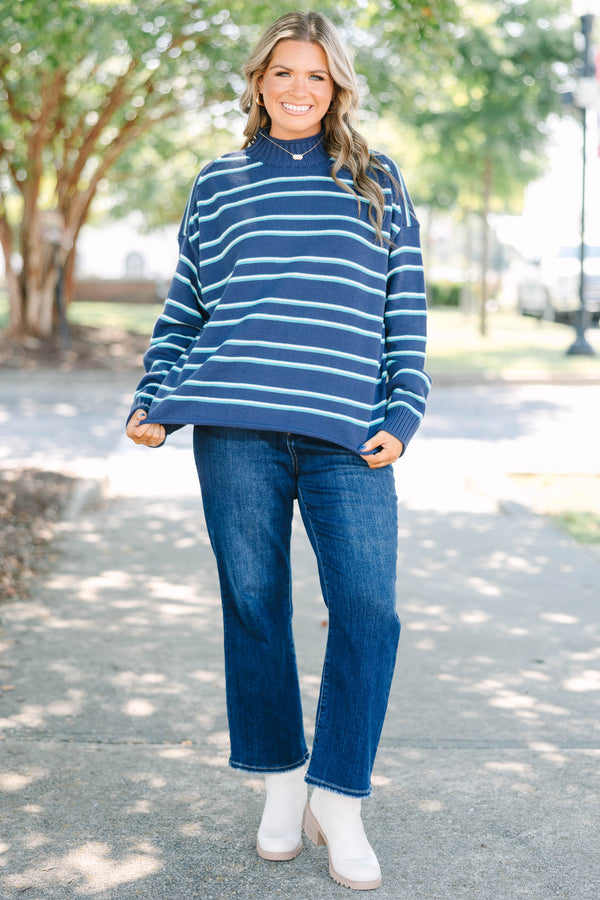 Plus Size navy rollneck sweater with horizontal teal and white stripes, long sleeves, and relaxed fit.