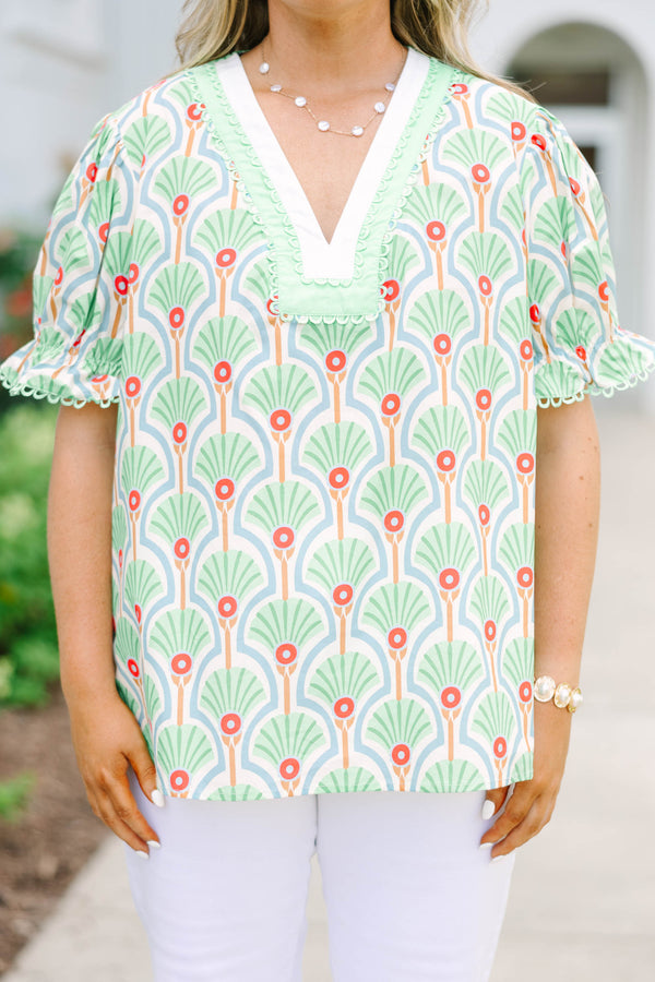 Plus size top in green with a fan print, V-neck, and ruffle puff sleeves.