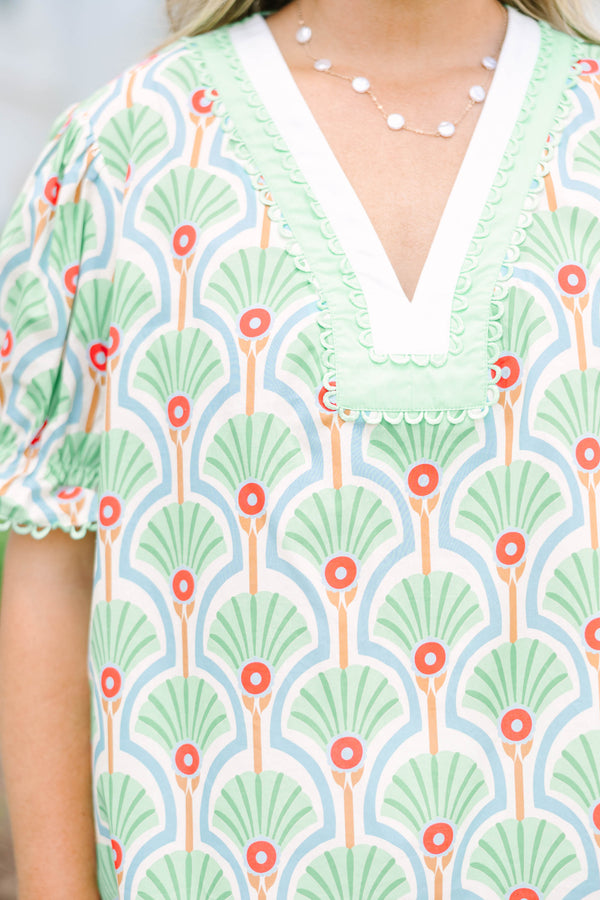Plus size top in green with a fan print, V-neck, and ruffle puff sleeves.