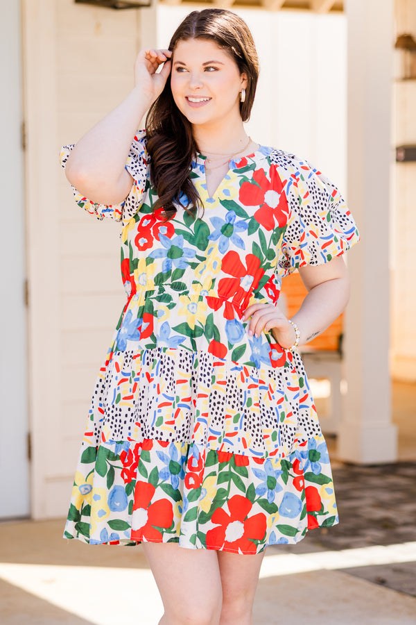 Chic Soul plus size clothing, short sleeve off white ruffled dress with small v-neckline and yellow, red, and blue patterns