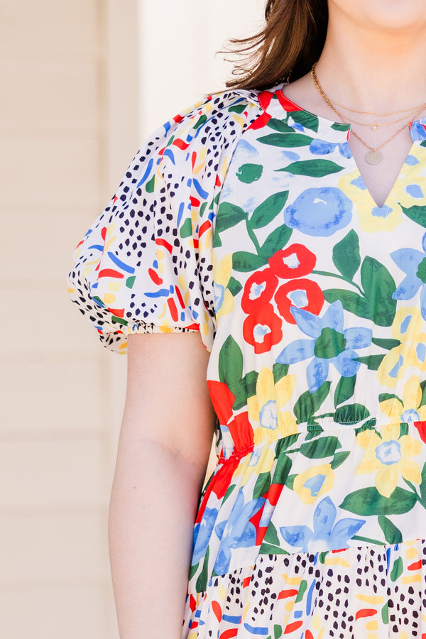 Chic Soul plus size clothing, short sleeve off white ruffled dress with small v-neckline and yellow, red, and blue patterns