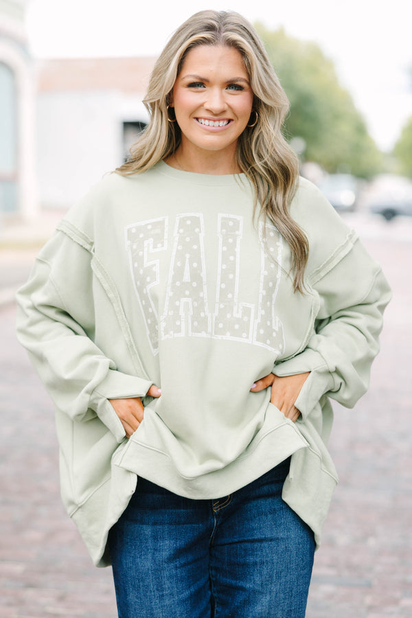 Plus Size light sage crew neck sweatshirt with a white polka dot 'FALL' graphic and raw seam detail.