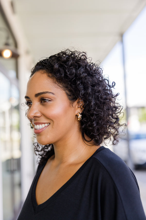 Plus Size gold hoop earrings with a textured finish and embedded sparkling silver gemstones.
