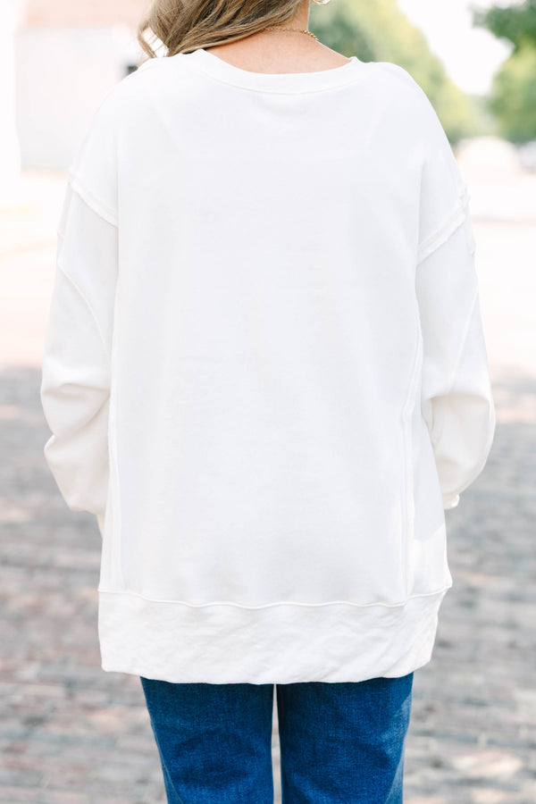 Plus Size ivory crew neck sweatshirt with a football-themed bow graphic and relaxed fit.