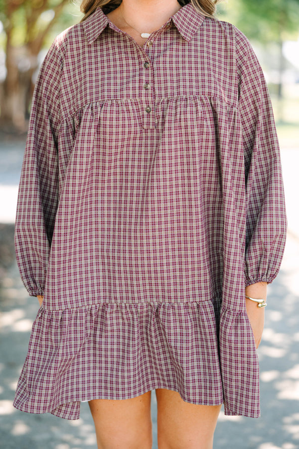 Plus Size burgundy plaid mini dress with a collared neckline, button-up bodice, and tiered skirt.