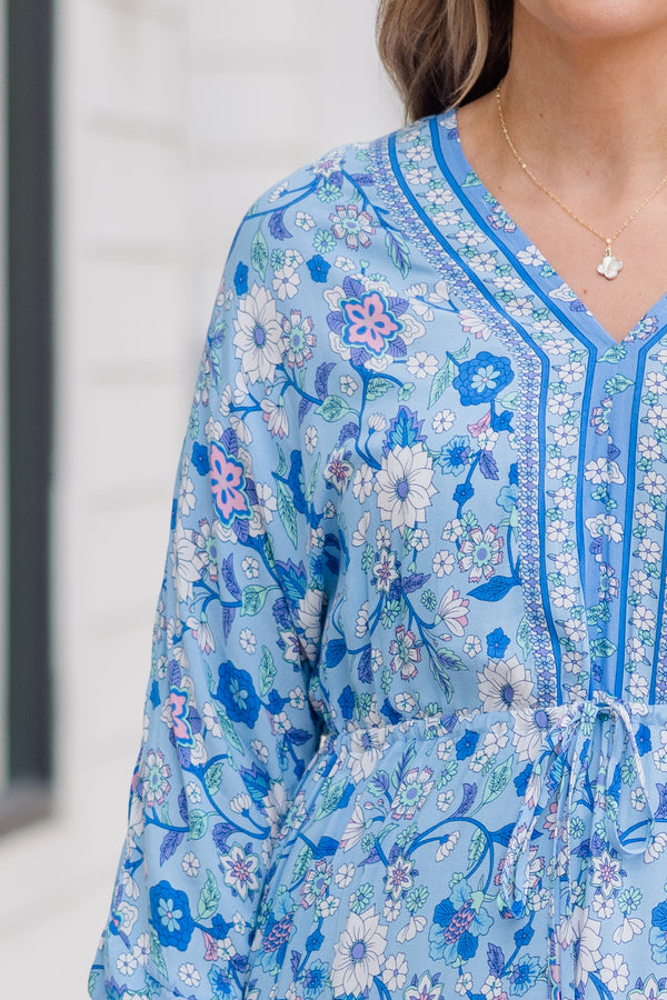 Plus Size blue floral maxi dress with long sleeves, a V-neckline, and tassel drawstring waist.