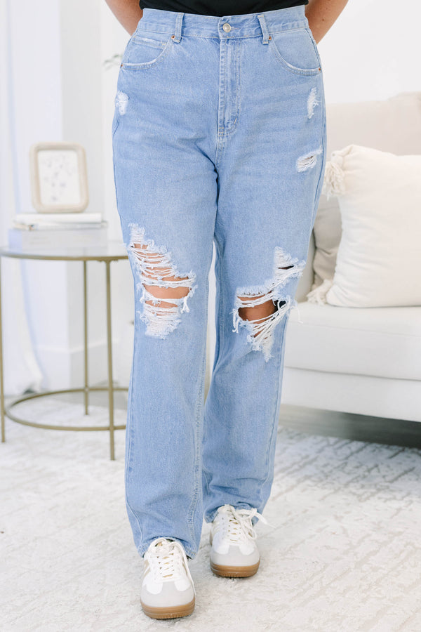 Plus Size light wash straight leg jeans with heavy distressing and ripped knees.