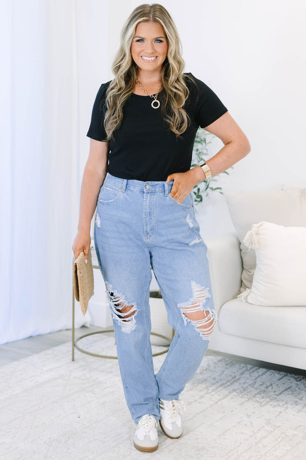 Plus Size light wash straight leg jeans with heavy distressing and ripped knees.