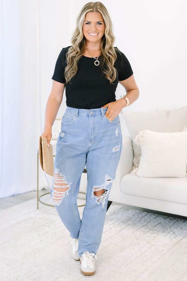 Plus Size light wash straight leg jeans with heavy distressing and ripped knees.