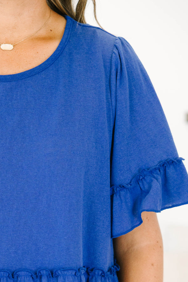 Plus size blue flowy top with ruffle sleeves and a tiered babydoll silhouette in a soft cotton blend