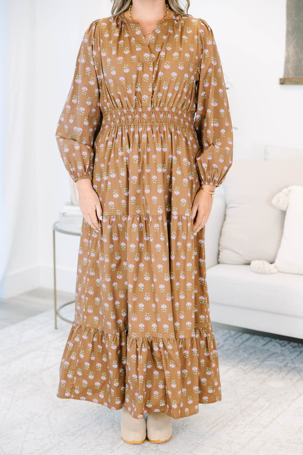 Plus size brown floral maxi dress with a smocked waist, tiered skirt, and long puff sleeves.