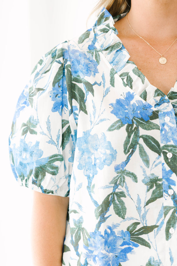 Plus Size ivory button-up top with blue floral print, ruffled collar, and puff sleeves.
