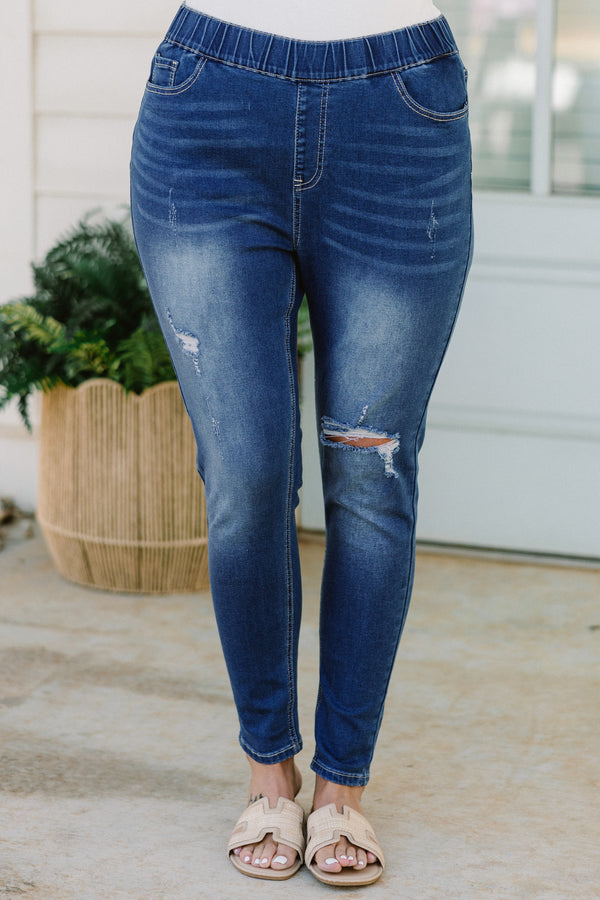 Plus Size medium wash distressed jeggings with an elastic waistband and a slim fit.