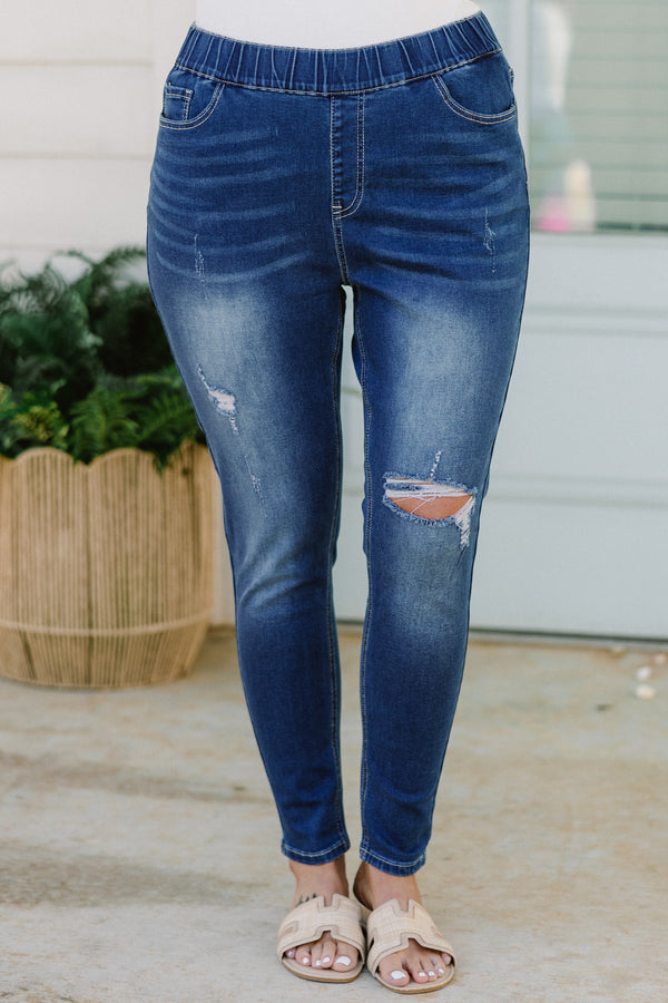 Plus Size medium wash distressed jeggings with an elastic waistband and a slim fit.