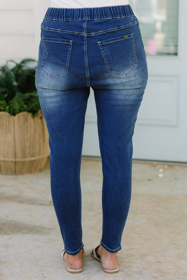 Plus Size medium wash distressed jeggings with an elastic waistband and a slim fit.