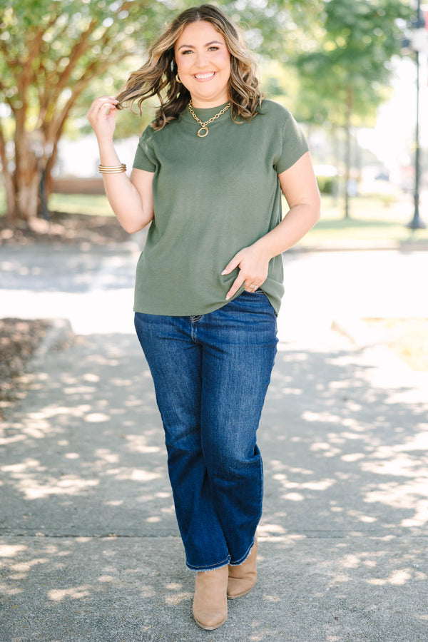 Plus Size olive green short sleeve sweater with a crew neckline and ribbed knit texture.