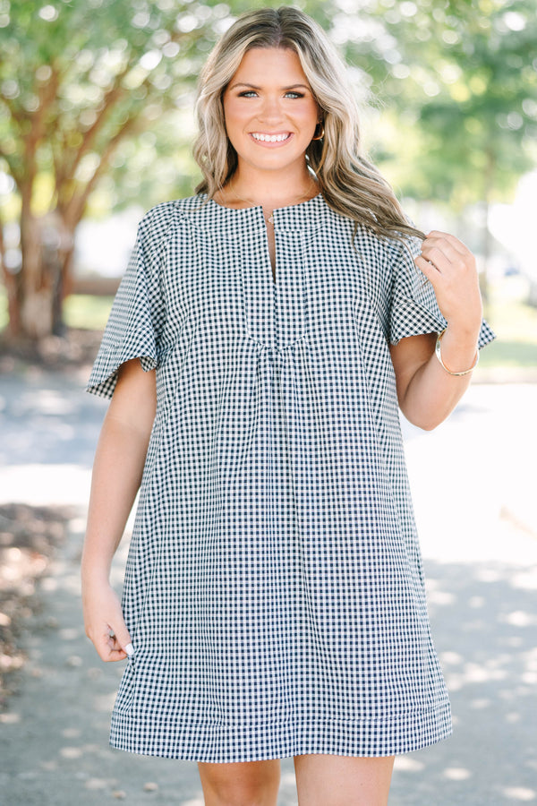 Plus Size black and white gingham dress with a split v-neckline and short flutter sleeves.