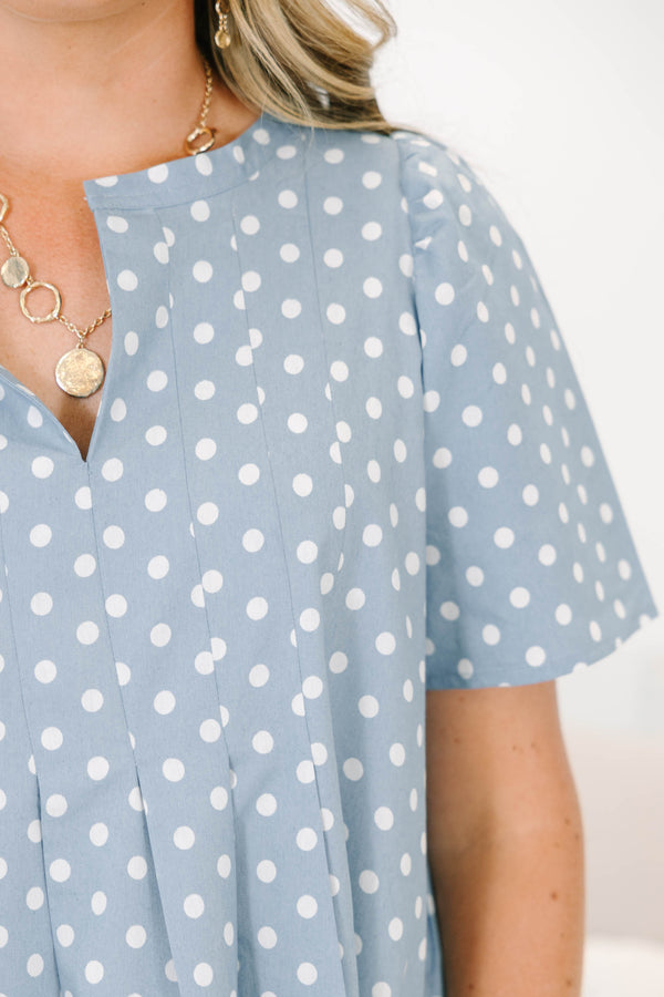 Plus Size blue polka dot dress with short puff sleeves, a V-neckline, and a flowy pleated skirt.