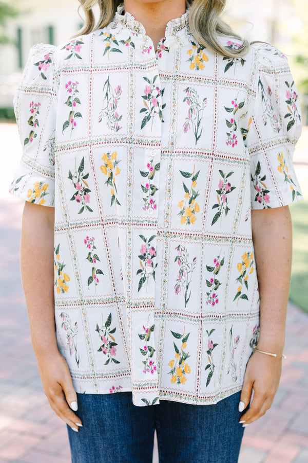 Plus size cream floral button-down top with puff sleeves and a ruffled collar.