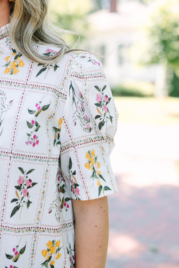 Plus size cream floral button-down top with puff sleeves and a ruffled collar.