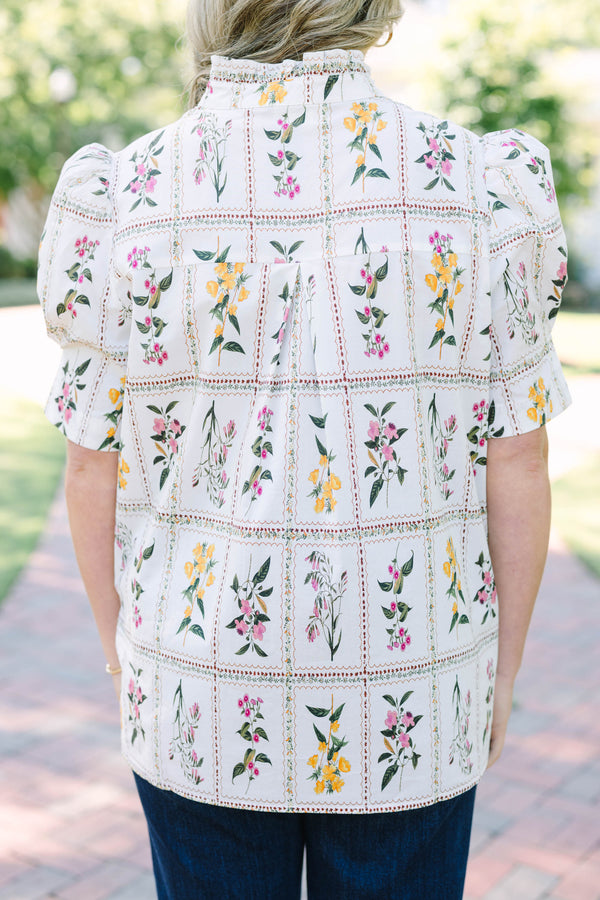 Plus size cream floral button-down top with puff sleeves and a ruffled collar.