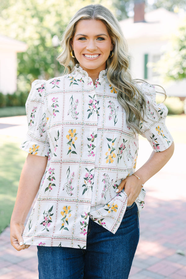 Plus size cream floral button-down top with puff sleeves and a ruffled collar.