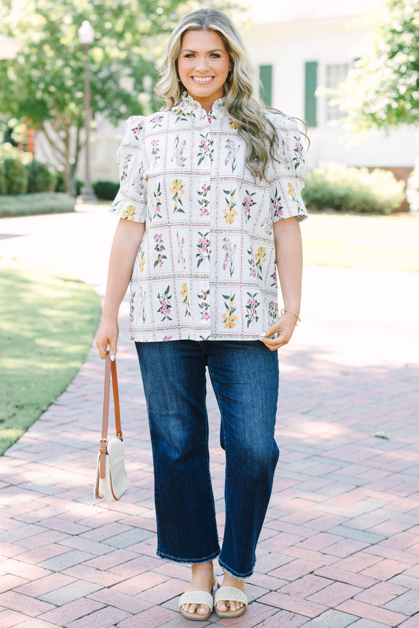 Plus size cream floral button-down top with puff sleeves and a ruffled collar.
