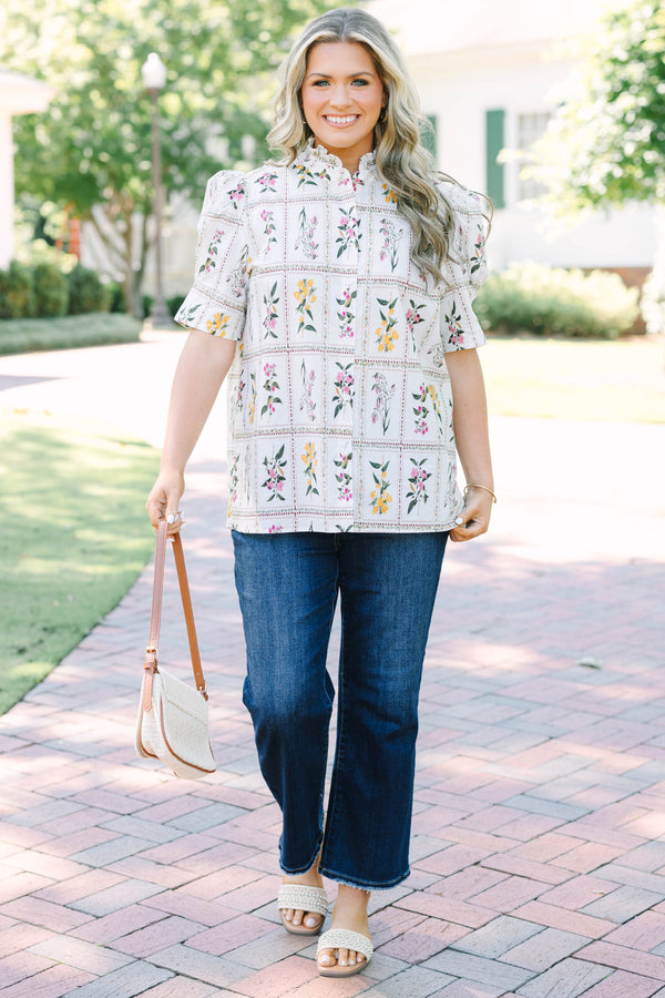 Plus size cream floral button-down top with puff sleeves and a ruffled collar.