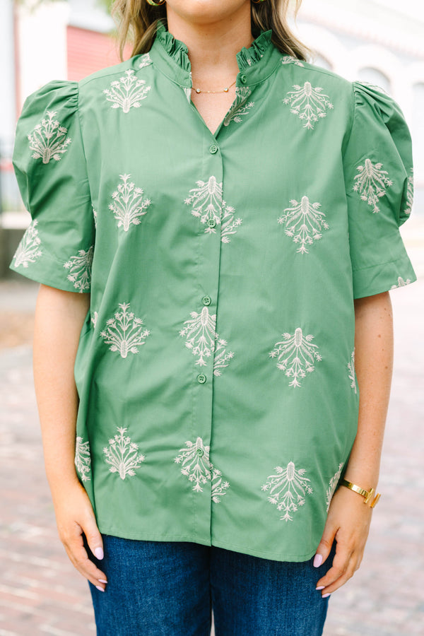 Plus Size olive green blouse with embroidered floral print, puff sleeves, and a ruffled mock neck.