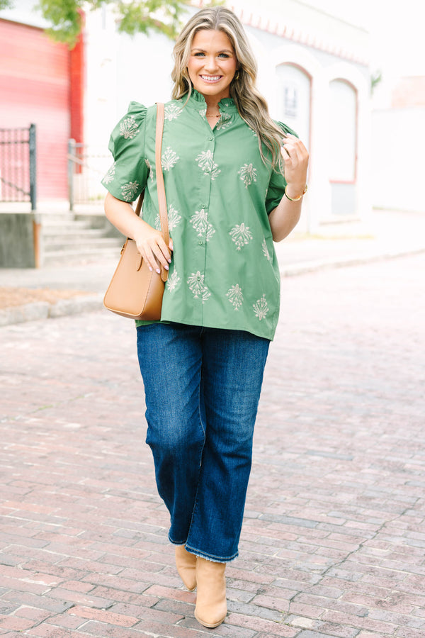 Plus Size olive green blouse with embroidered floral print, puff sleeves, and a ruffled mock neck.
