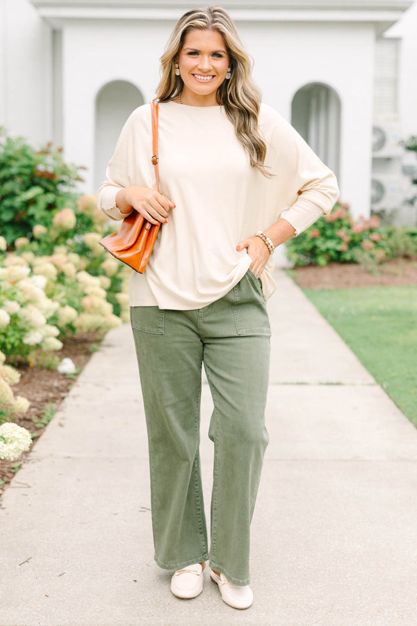 Plus Size beige relaxed fit knit sweater with a round neckline and button-cuffed long sleeves.