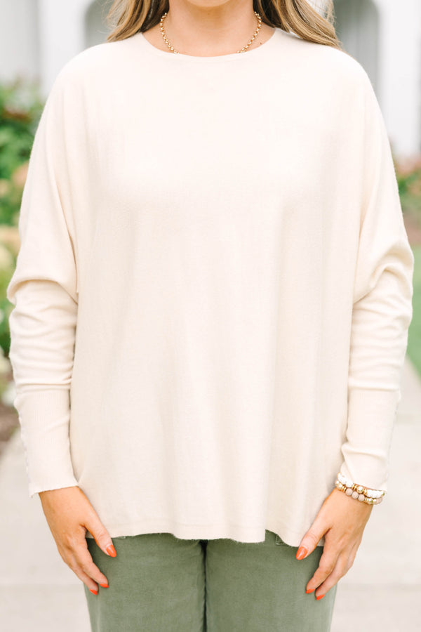 Plus Size beige relaxed fit knit sweater with a round neckline and button-cuffed long sleeves.