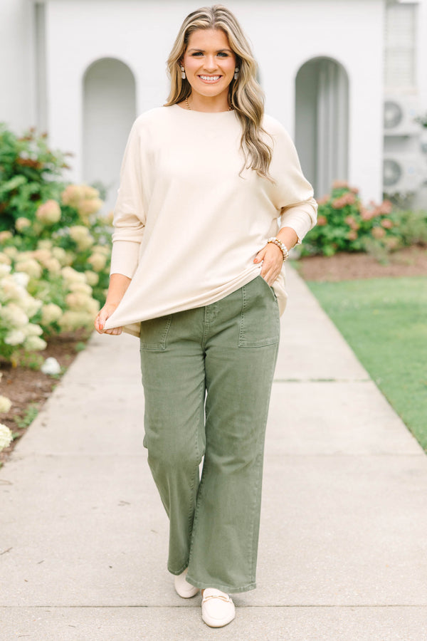 Plus Size beige relaxed fit knit sweater with a round neckline and button-cuffed long sleeves.