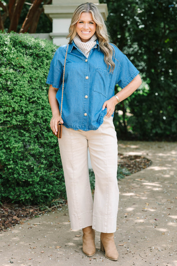 Plus size short-sleeve denim shirt with statement buttons, scalloped pocket, and a relaxed fit.