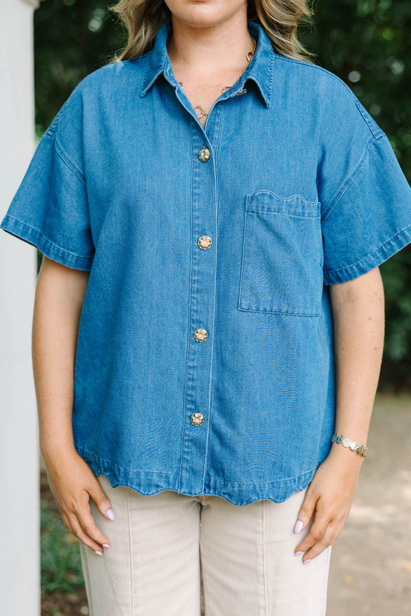 Plus size short-sleeve denim shirt with statement buttons, scalloped pocket, and a relaxed fit.