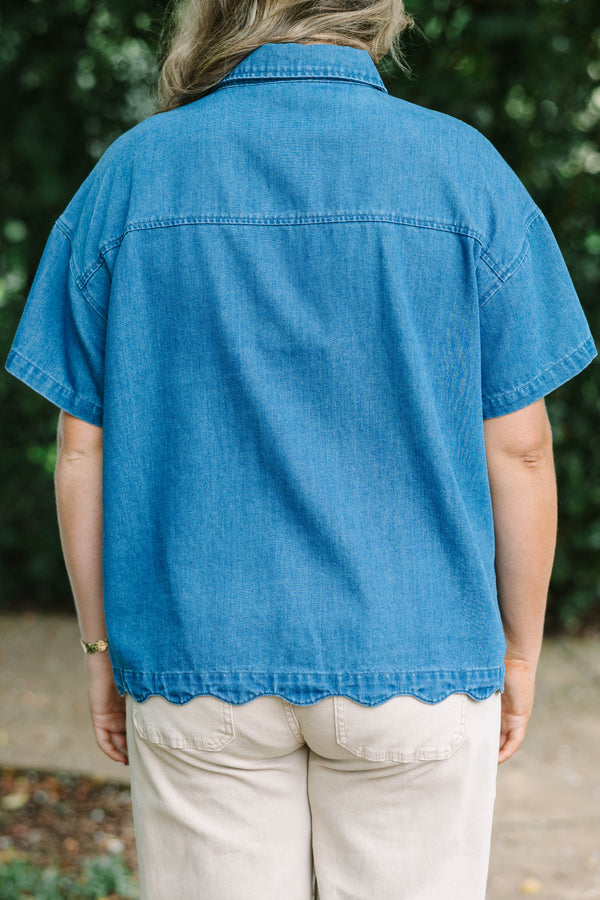 Plus size short-sleeve denim shirt with statement buttons, scalloped pocket, and a relaxed fit.