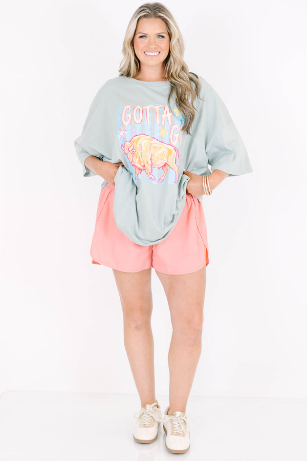 Plus Size light sage boyfriend tee with a buffalo graphic and pink athletic shorts.