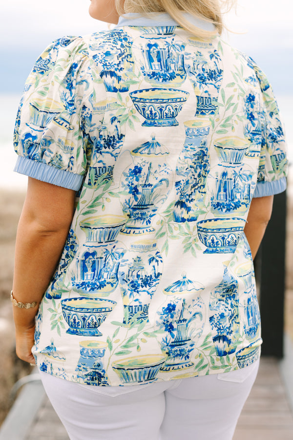 Chic Soul plus size clothing, blue top with a chinoiserie printed pattern throughout and light blue cuffs at the end of each sleeve and along the v-neckline 