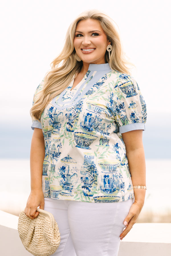 Chic Soul plus size clothing, blue top with a chinoiserie printed pattern throughout and light blue cuffs at the end of each sleeve and along the v-neckline 