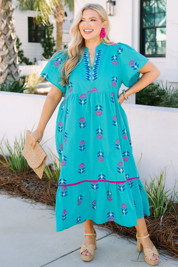 Chic Soul plus size clothing, turquoise maxi dress with short sleeves and a slight v-neckline as well as a floral block pattern throughout and pink stitching details on the bottom tier of the dress 