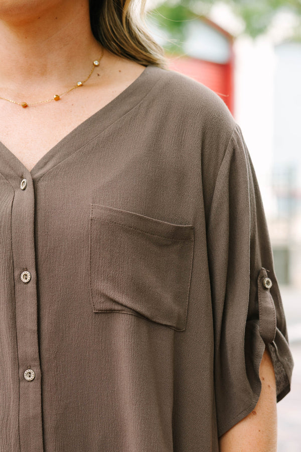 Plus Size brown short sleeve button-down blouse with a v-neckline and front chest pockets.
