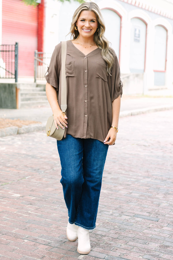 Plus Size brown short sleeve button-down blouse with a v-neckline and front chest pockets.