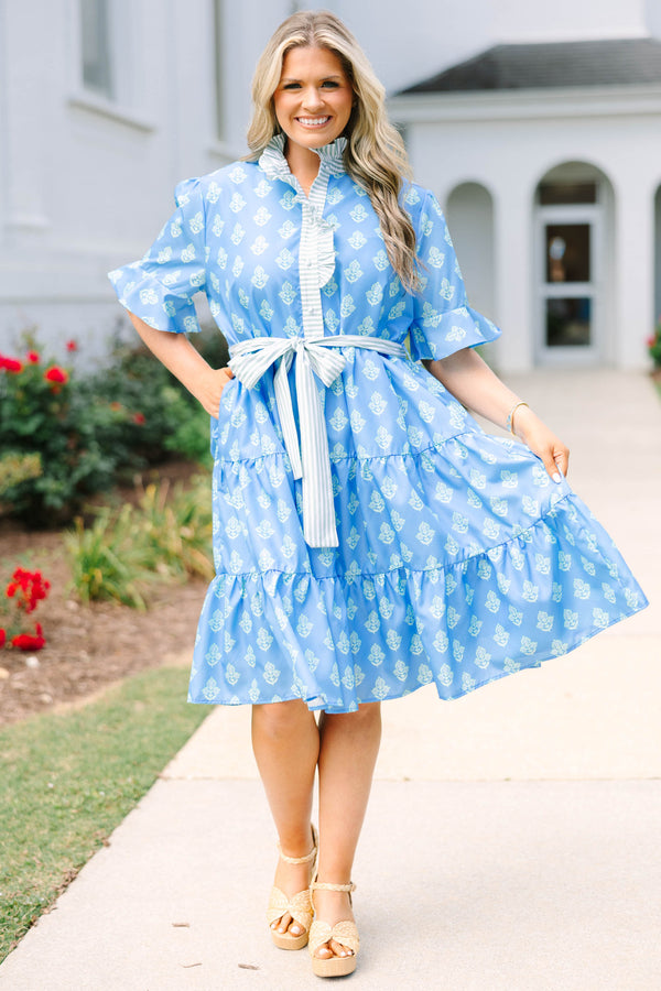 Plus Size blue tiered dress with white floral print, ruffled collar, and striped waist tie.