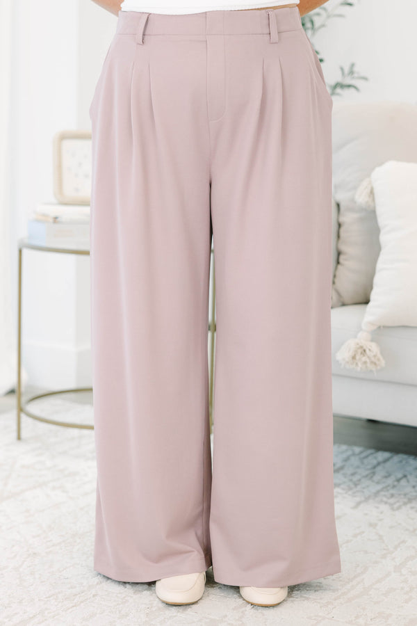 Plus size dusty rose wide-leg trousers with a flowy fit, pleated front, and belt loops.