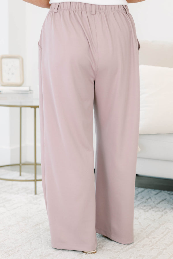 Plus size dusty rose wide-leg trousers with a flowy fit, pleated front, and belt loops.