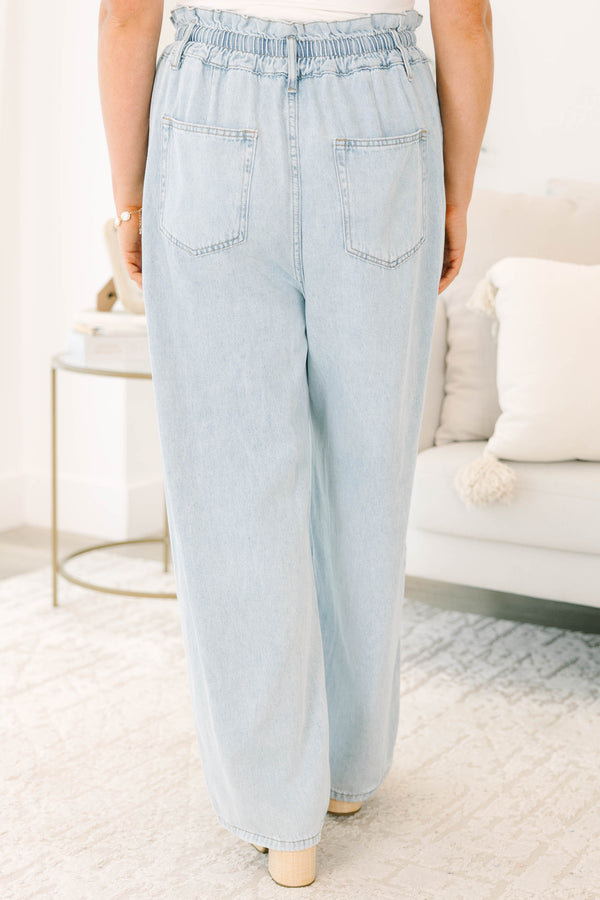 Plus Size light wash wide-leg jeans with an elastic drawstring waist and front pockets.