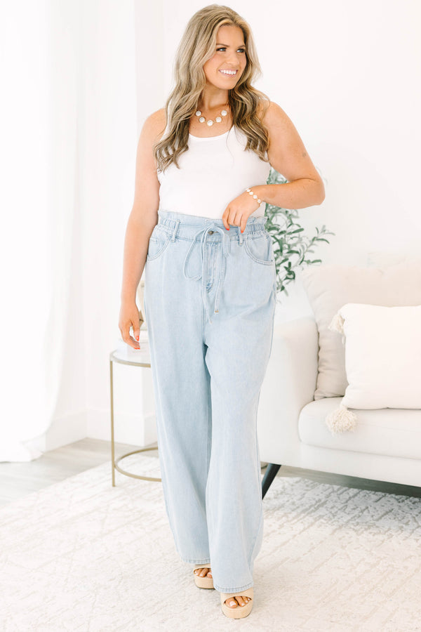 Plus Size light wash wide-leg jeans with an elastic drawstring waist and front pockets.