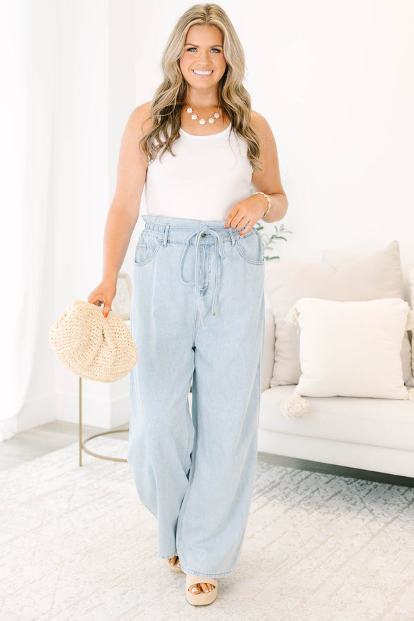 Plus Size light wash wide-leg jeans with an elastic drawstring waist and front pockets.