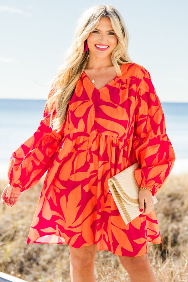 Chic Soul plus size clothing, orange long sleeve mini dress with tiered sleeve detail with v neckline and cuff puff sleeves with large abstract pink print
